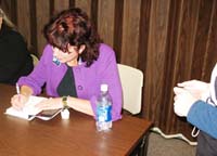 Beckie Weinheimer signing books at Algona Public Library, Algona, Iowa